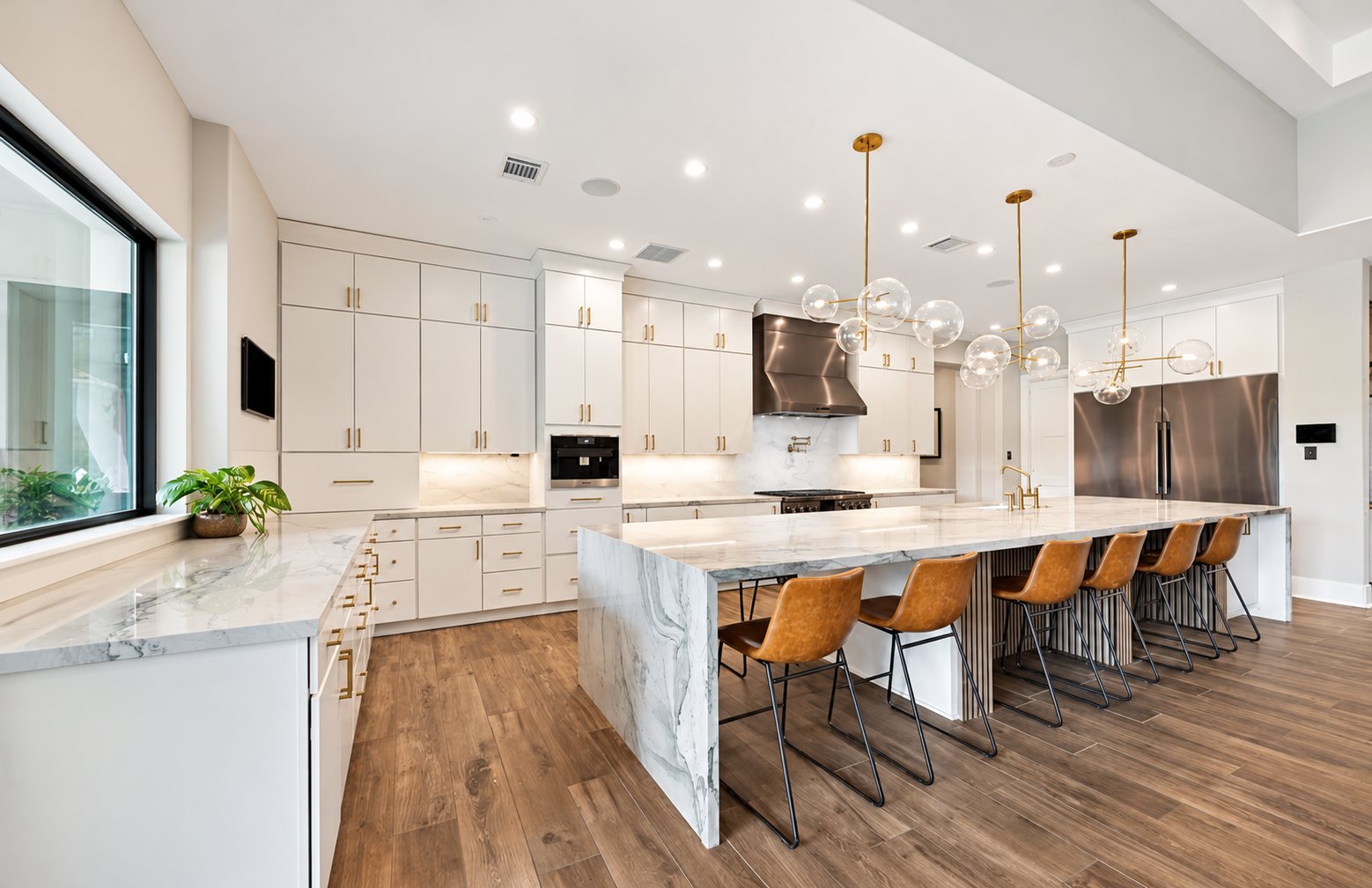 Bright kitchen with a long island, pendant lights and counter seating